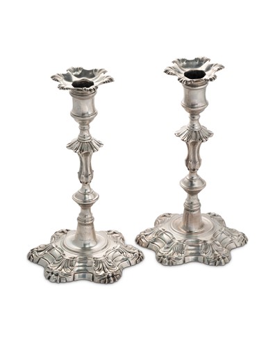 Lot 322 - A near visual pair of George II cast silver candlesticks