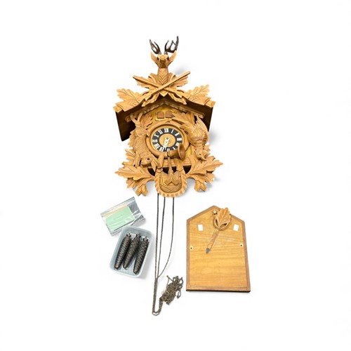 Lot 179 - A modern cuckoo clock, in typical carved case