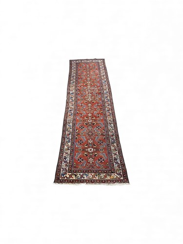 Lot 818 - A Heriz runner, the red ground with blue...