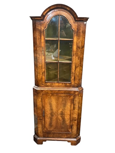 Lot 629 - A 1930s walnut floor standing corner cupboard,...