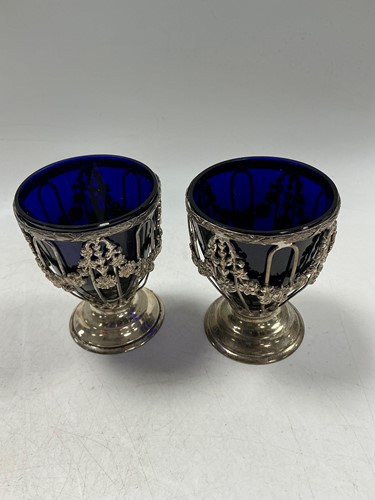 Lot 325 - A pair of Edwardian silver and glass sugar...