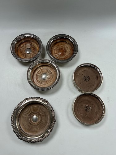 Lot 334 - A group of of six silver plated wine/bottle...