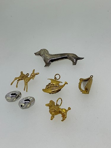Lot 270 - Four charms including a poodle and a deer,...