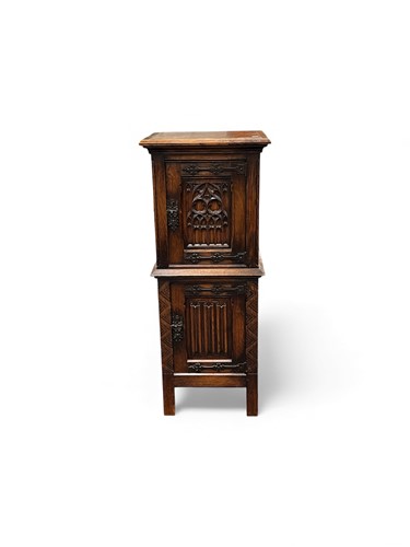 Lot 681 - A tall oak two door cupboard, the door fronts...