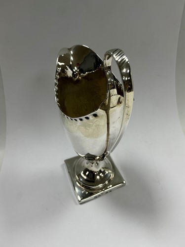 Lot 339 - A George III silver helmet cream jug, London,...