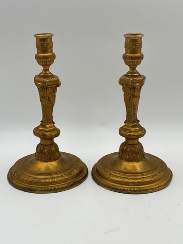 Lot 110 - A pair of gilt metal table candlesticks in the...