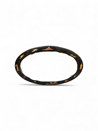 Lot 803 - A Chinoiserie black lacquered oval wall mirror,...