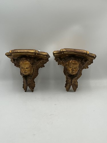 Lot 221 - A pair of gilt gesso wall brackets modelled as...