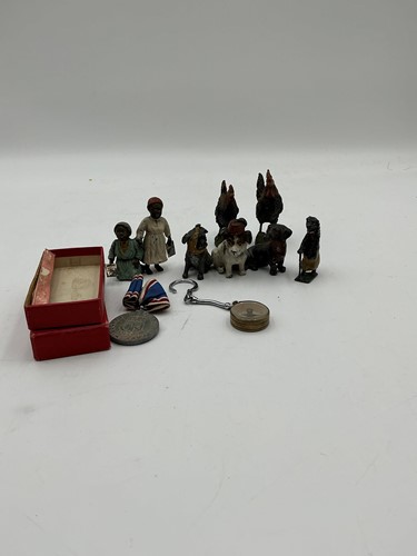 Lot 87 - A painted lead model dog trio, a pair of robed...