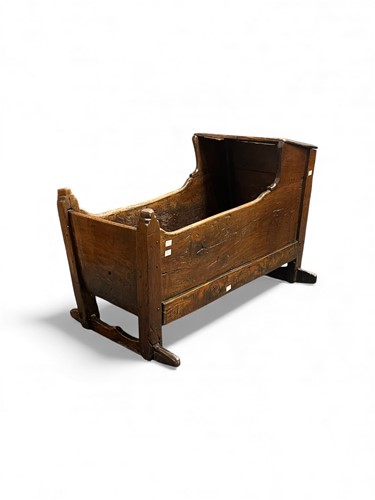 Lot 657 - An antique oak and softwood crib, with carved...