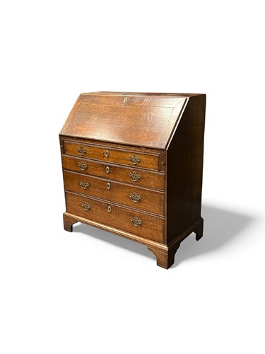 Lot 680 - A George III oak bureau, the fall front with...