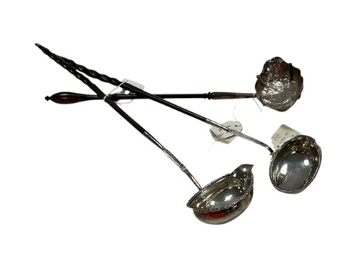 Lot 284 - Three Georgian hallmarked silver toddy ladles,...
