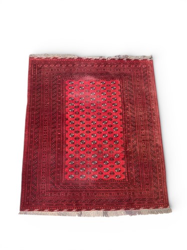 Lot 825 - A Bokhara red ground rug, rows of medallions...
