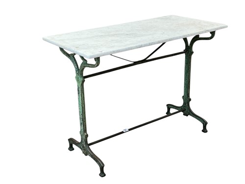 Lot 380 - A marble topped iron framed garden table, 20th...