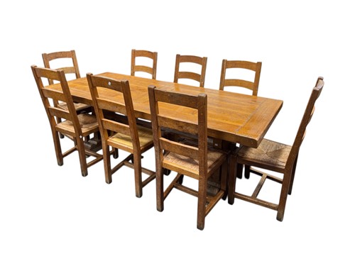 Lot 454 - A rustic oak refectory table and eight ladder...