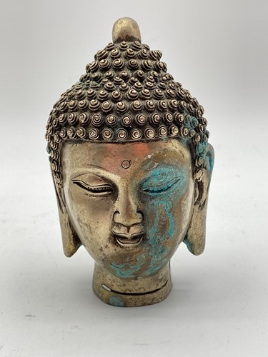 Lot 34 - A cast metal Buddha head 15cm