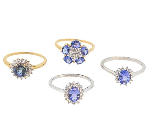 Lot 28 - A group of four 9ct gold tanzanite and zircon cluster rings
