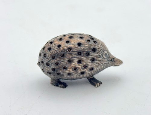 Lot 76 - An Edwardian silver hedgehog pin cushion