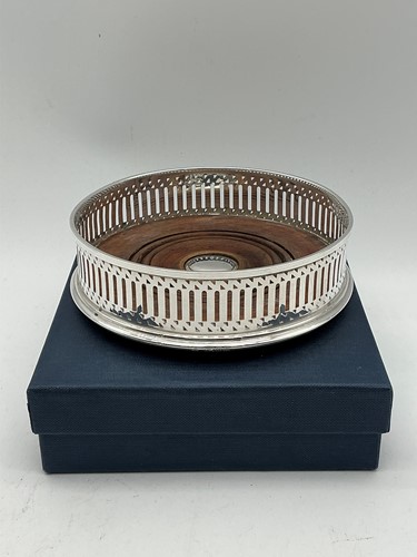 Lot 170 - A modern silver wine bottle coaster by M C...
