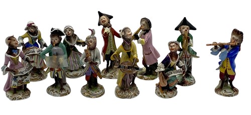 Lot 23 - German porcelain monkey band figures, painted...