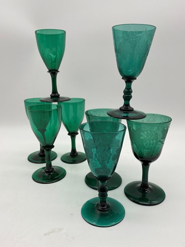 Lot 4 - A set of four green glasses engraved with...
