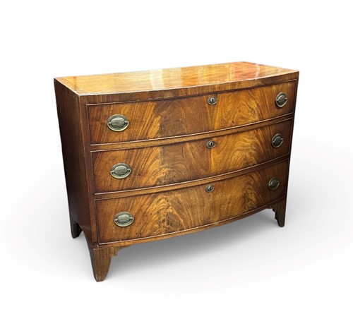 Lot 413 - A bow fronted mahogany chest of three drawers,...