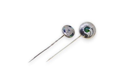 Lot 178 - Liberty & Co., two Cymric silver and enamel stick pins