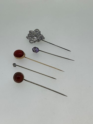 Lot 177 - An oval red paste stick pin tested as 9ct gold...