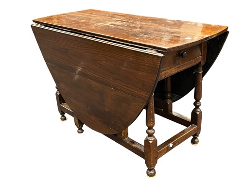 Lot 588 - An oval oak drop leaf gateleg table, 19th...