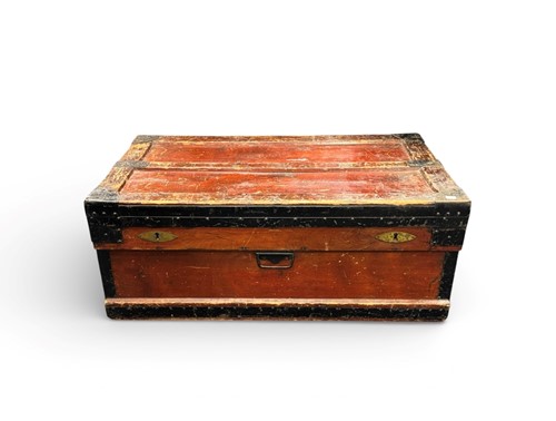 Lot 386 - A low red lacquered and metal strapped...