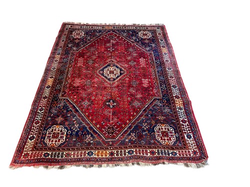Lot 482 - A Qashqai wool rug, with a central lozenge on...