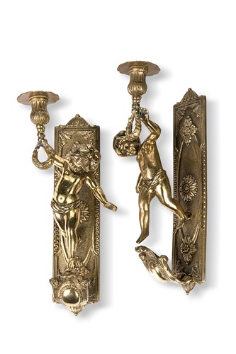 Lot 85 - A pair of brass single brass figural sconces