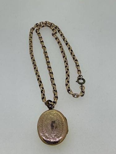 Lot 180 - A locket tested as 9ct gold with a base metal...