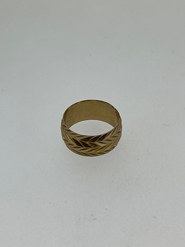Lot 176 - A hallmarked 9ct gold band with diamond cut...