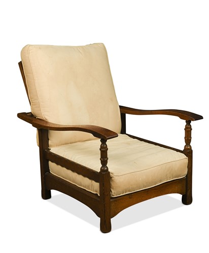 Lot 202 - A Cotswold School oak reclining armchair