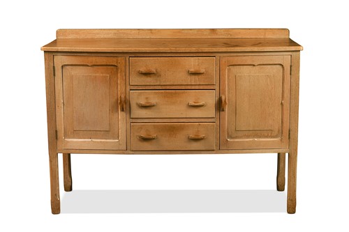 Lot 203 - A Cotswold School limed oak sideboard in the manner of Gordon Russell