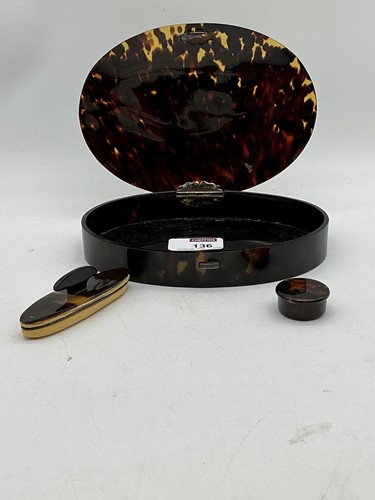 Lot 136 - Oval tortoiseshell dressing table box with...