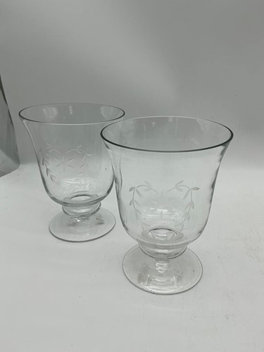 Lot 133 - A pair of heart engraved glass candle holders,...