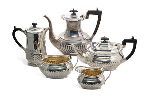 Lot 401 - A George V silver five piece tea set