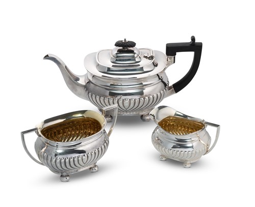 Lot 410 - A George V silver three piece tea and coffee set