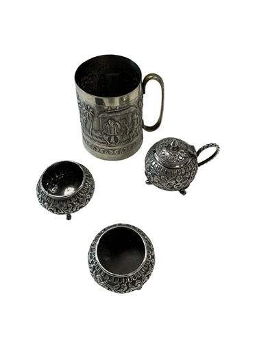 Lot 328 - An Indian silver mug, the body embossed with a...