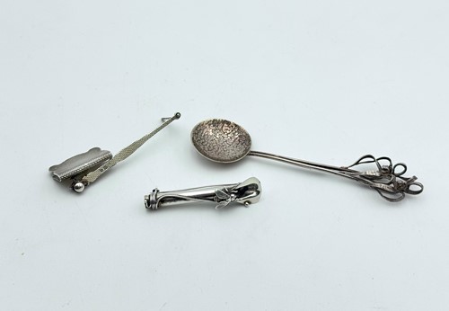 Lot 83 - A silver bookmark by Asprey, together with a spoon and corsage holder
