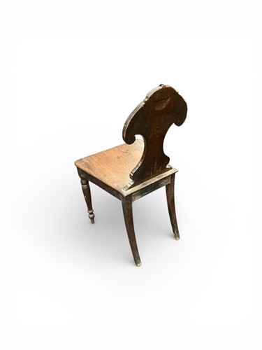 Lot 398 - A late Regency mahogany hall chair with pelta...