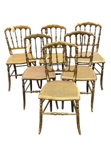 Lot 606 - A matched set of seven gilt painted wood chairs, 20th century