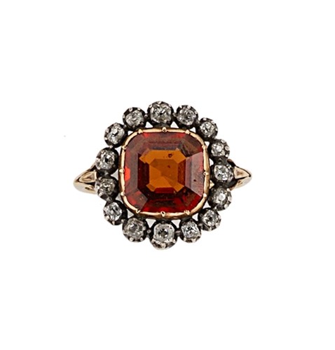Lot 26 - A hessonite garnet and diamond cluster ring