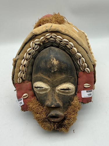 Lot 199 - An Ivory Coast tribal mask, fabric, wood and...