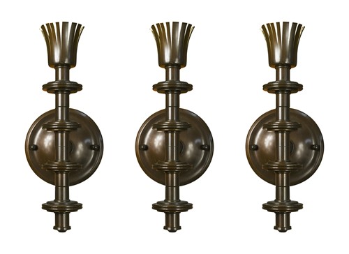 Lot 679 - A set of three bronze wall lights, modern