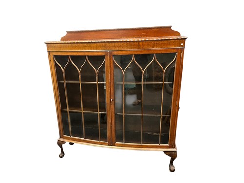 Lot 641 - A 1920s mahogany bowfront glazed two door...