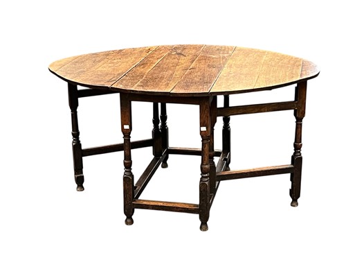 Lot 639 - An 18th century oak shaped oval gateleg table