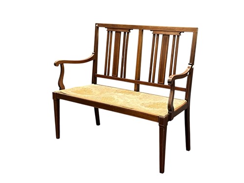 Lot 638 - An Edwardian mahogany and strung two seat settee